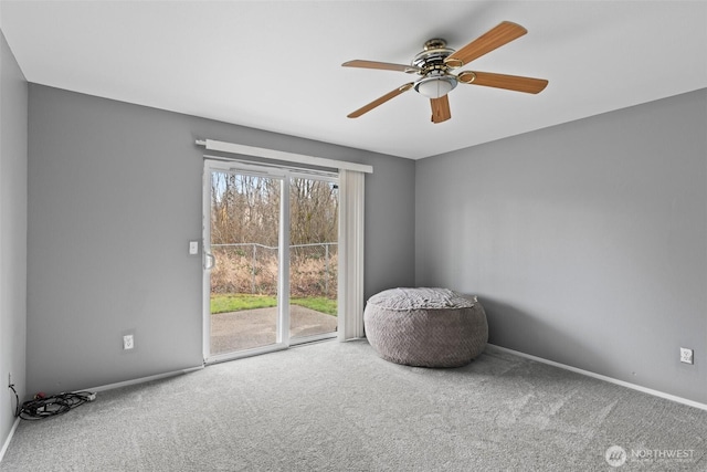 sitting room featuring baseboards, carpet floors, and ceiling fan