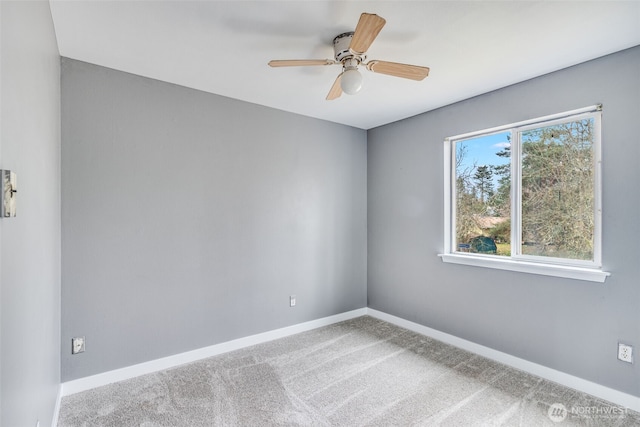 unfurnished room with a ceiling fan, carpet, and baseboards