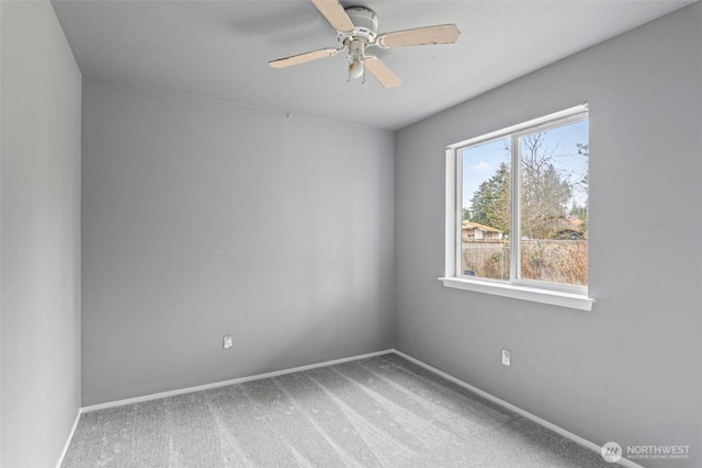 spare room with baseboards, ceiling fan, and carpet flooring