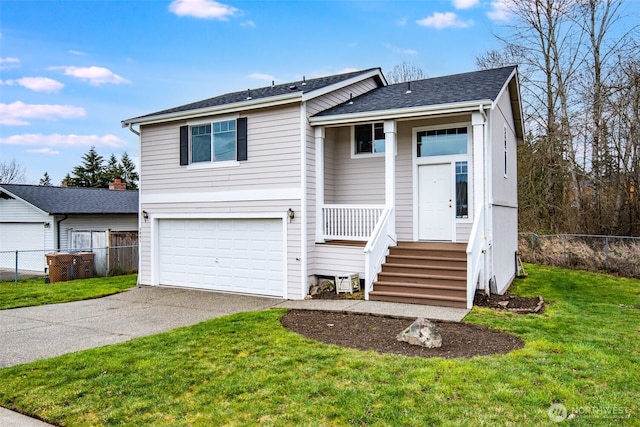 view of front of home featuring a garage, driveway, a front yard, and fence