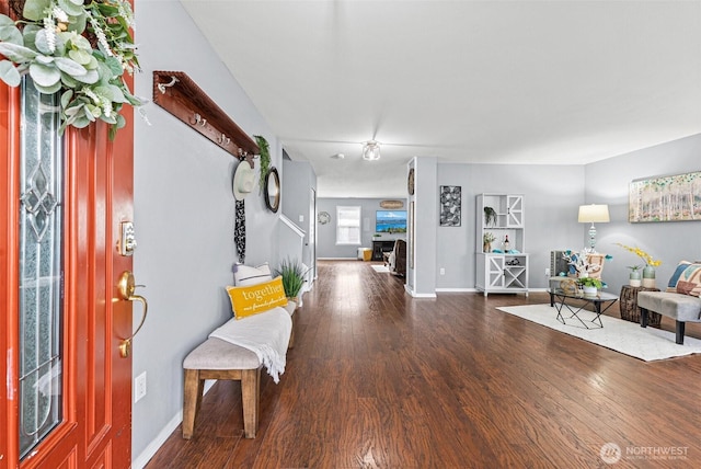 foyer with wood finished floors and baseboards