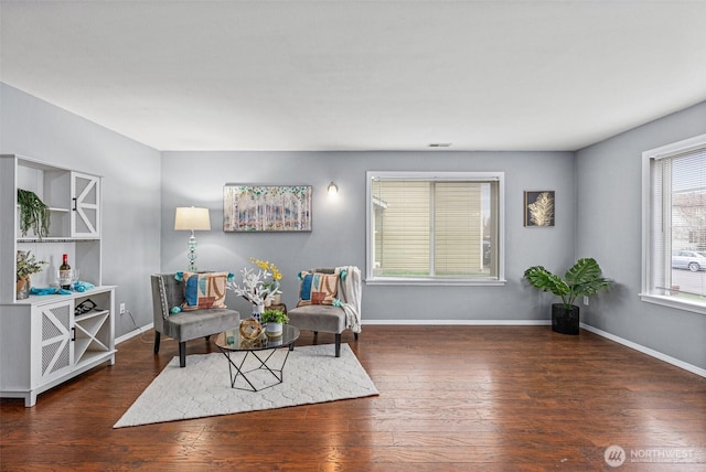 living area featuring baseboards and wood finished floors