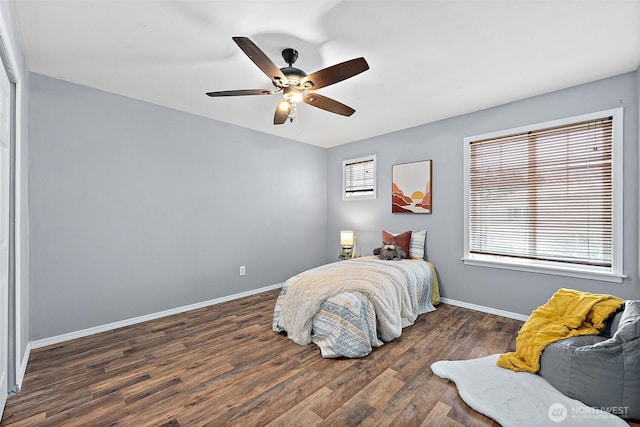 bedroom featuring ceiling fan, baseboards, and wood finished floors