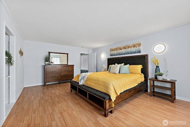 bedroom featuring baseboards, light wood-style floors, and crown molding