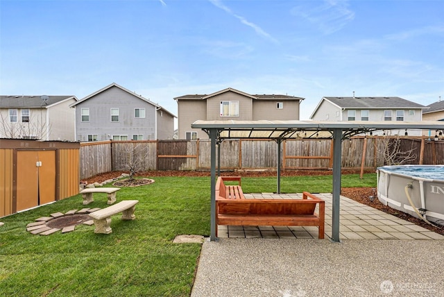 view of yard featuring a residential view, a patio, a fenced in pool, and a fenced backyard