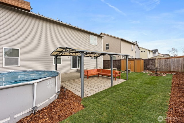 back of house with a patio area, a lawn, a pergola, and a fenced backyard