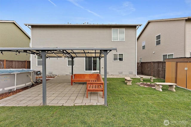 rear view of property with a fenced in pool, fence, a yard, a pergola, and a patio