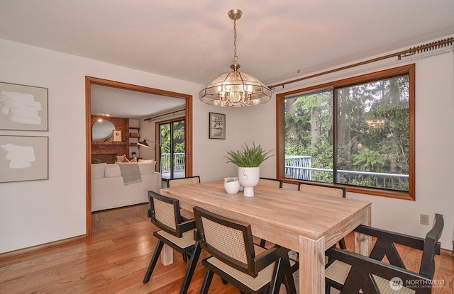 dining room with an inviting chandelier and light wood-type flooring