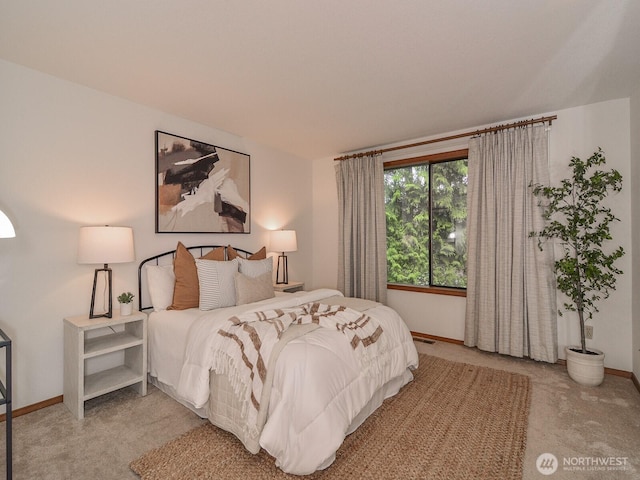 carpeted bedroom with baseboards