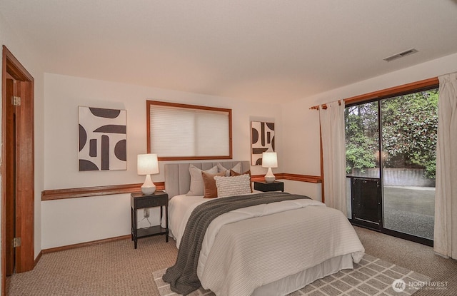 bedroom with visible vents, baseboards, carpet, and access to exterior