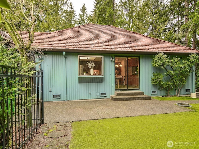 view of front of home with entry steps, a patio area, fence, and crawl space