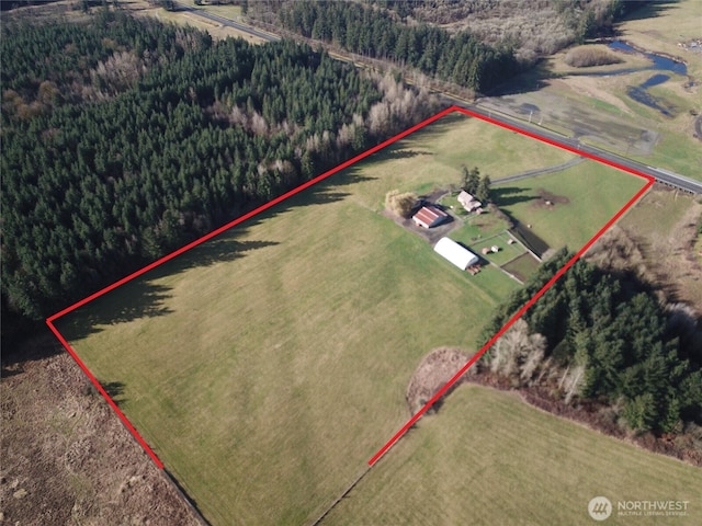 birds eye view of property with a rural view and a wooded view