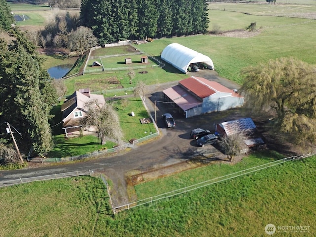 birds eye view of property with a water view and a rural view