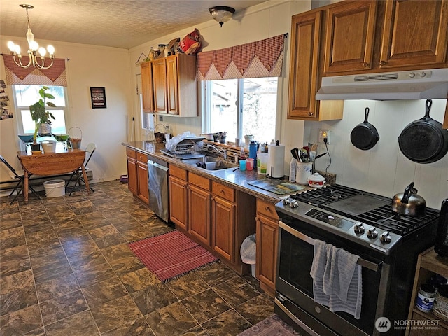 kitchen with an inviting chandelier, brown cabinetry, under cabinet range hood, and stainless steel appliances