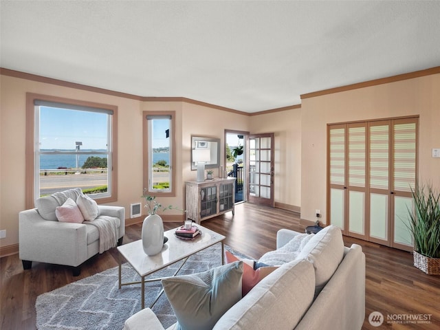 living room with wood finished floors, baseboards, and a healthy amount of sunlight