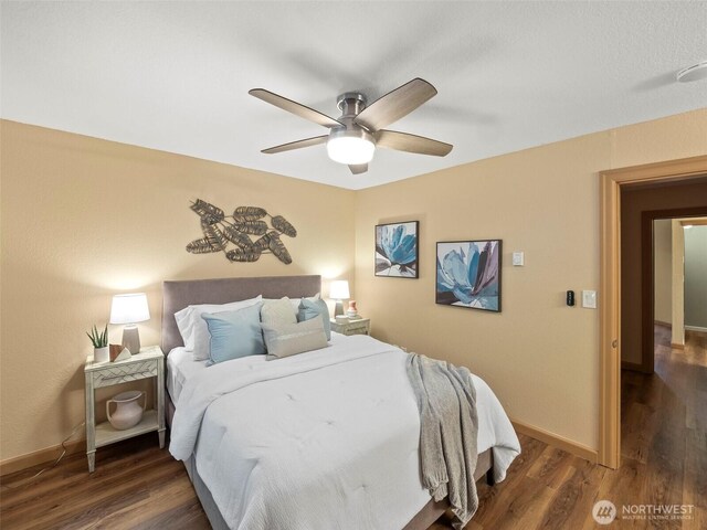 bedroom with wood finished floors, baseboards, and ceiling fan