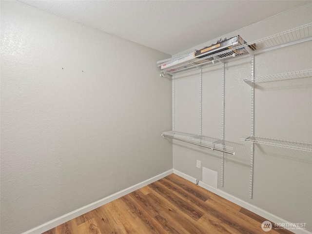 spacious closet with wood finished floors