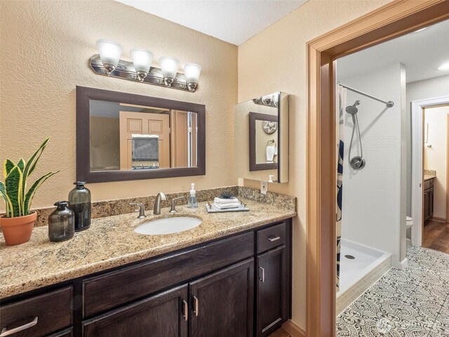 full bath featuring a shower stall and vanity