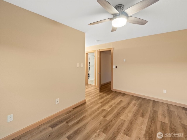 unfurnished room featuring ceiling fan, baseboards, and light wood-style floors