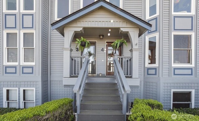 view of exterior entry with covered porch