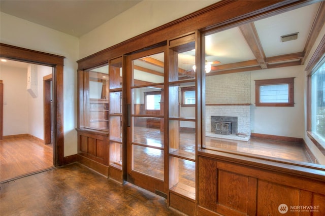 interior space with visible vents, beam ceiling, baseboards, and wood finished floors