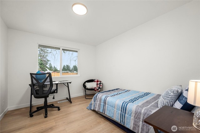 bedroom featuring light wood-type flooring and baseboards