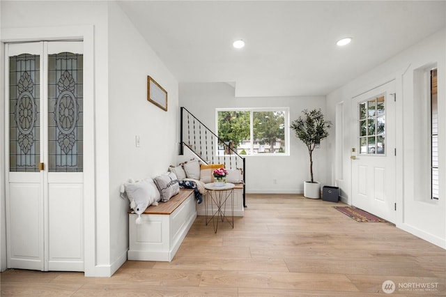 entryway featuring recessed lighting, light wood-type flooring, baseboards, and stairs