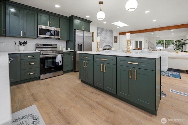 kitchen featuring light countertops, appliances with stainless steel finishes, and green cabinetry