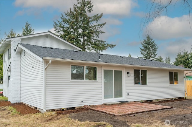 back of property featuring crawl space, a patio, and roof with shingles