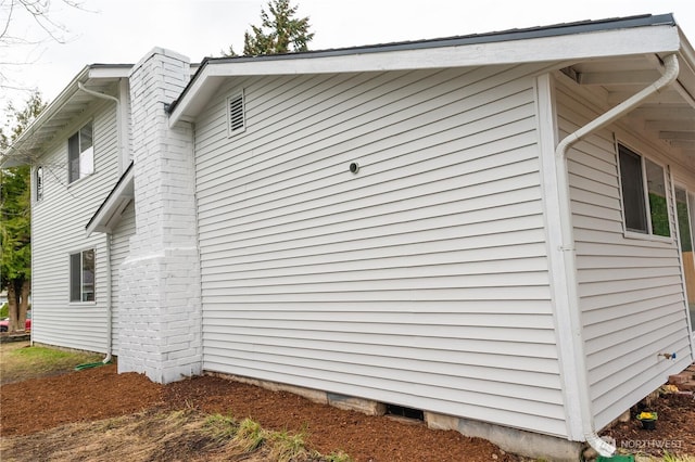 view of property exterior featuring a chimney