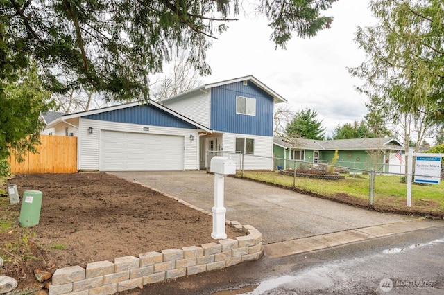 traditional-style home with an attached garage, fence, and driveway