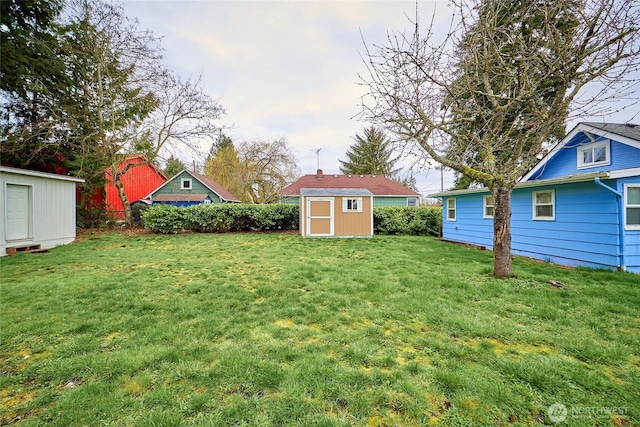 view of yard with an outbuilding and a storage shed