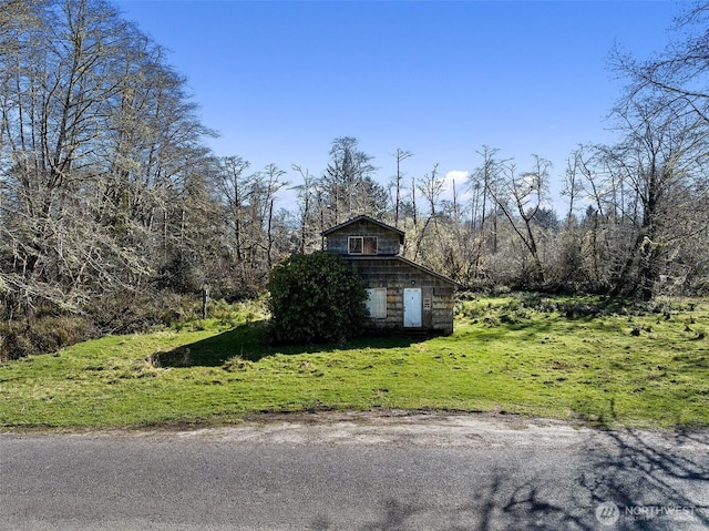 view of property exterior with a lawn