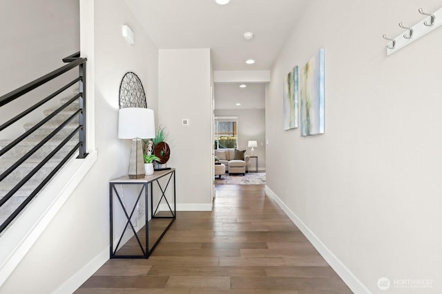 hallway featuring recessed lighting, baseboards, and wood finished floors