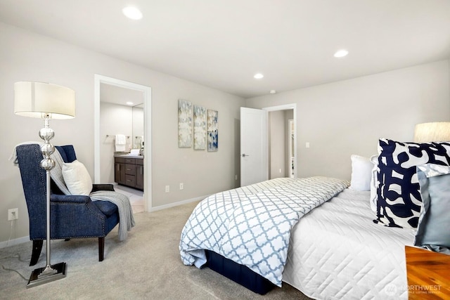 bedroom with ensuite bath, recessed lighting, baseboards, and light carpet