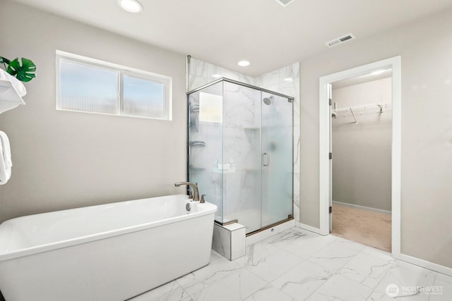 full bathroom with a freestanding tub, visible vents, marble finish floor, a stall shower, and a spacious closet