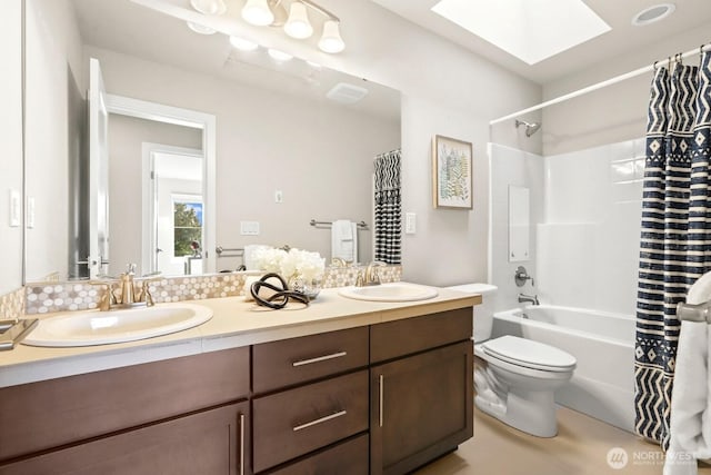 full bathroom with shower / bath combination with curtain, a skylight, visible vents, and a sink