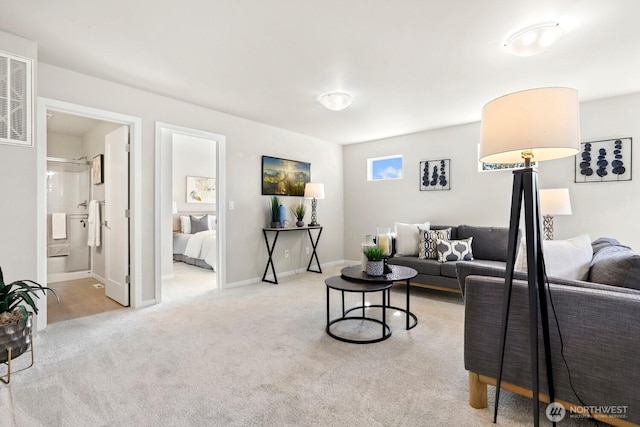 carpeted living room featuring visible vents and baseboards