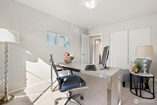 office space with baseboards and light colored carpet