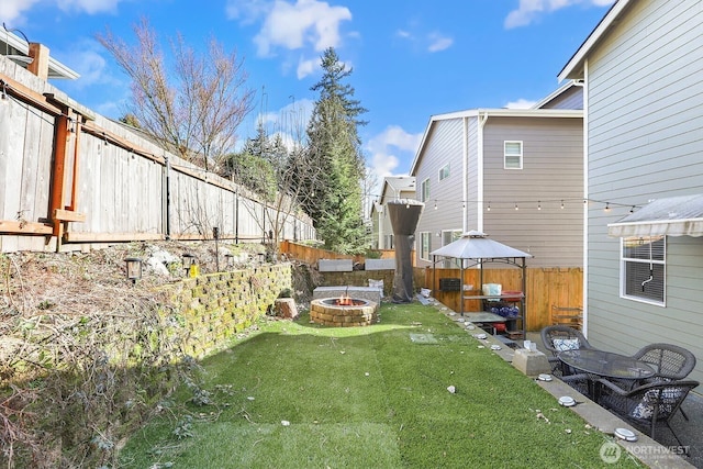 view of yard with a fire pit and a fenced backyard