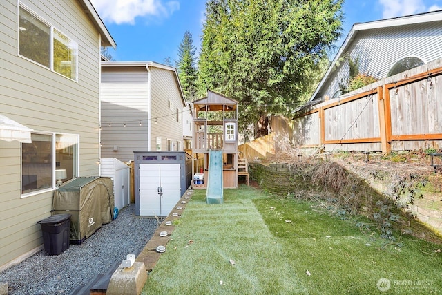 view of yard with a playground and a fenced backyard