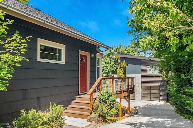 property entrance featuring driveway and a wooden deck