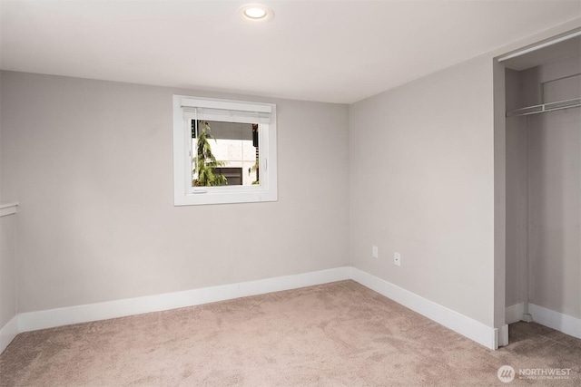 unfurnished bedroom featuring a closet, baseboards, and carpet floors