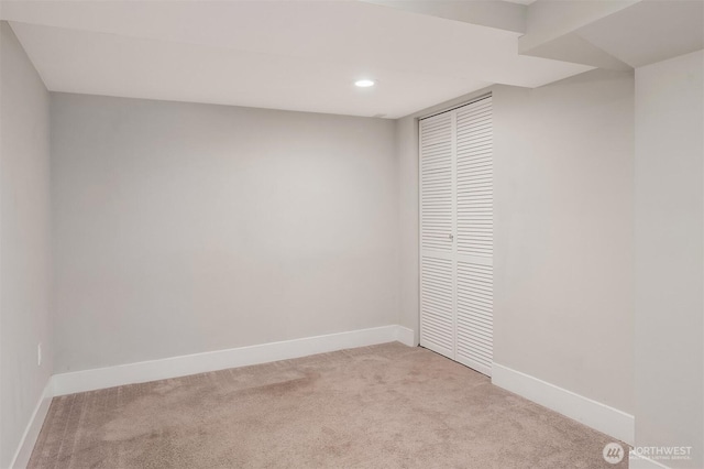 unfurnished room with light carpet, recessed lighting, and baseboards