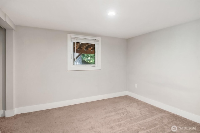 empty room featuring baseboards and carpet flooring