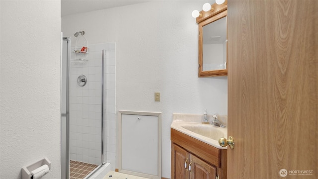 bathroom featuring a stall shower and vanity