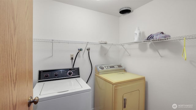 washroom featuring washer and dryer and laundry area