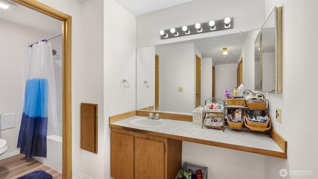 bathroom featuring toilet, vanity, and shower / bath combination with curtain