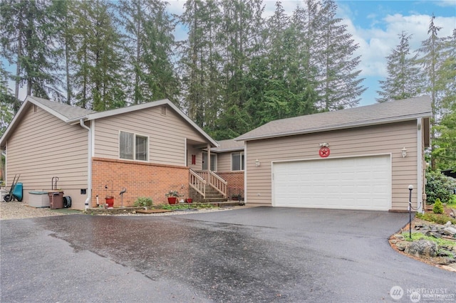 single story home with brick siding and aphalt driveway