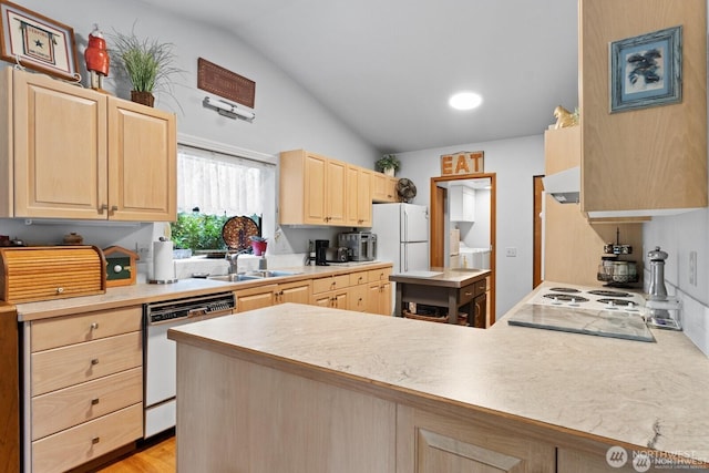 kitchen with light brown cabinets, a peninsula, a sink, light countertops, and dishwasher